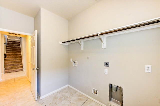 2831 Lake Villa Dr, Missouri City, TX 77459 - laundry area featuring hookup for an electric dryer, light tile patterned flooring, gas dryer hookup, washer hookup, and baseboards