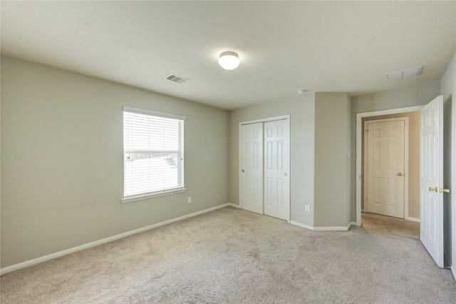 2831 Lake Villa Dr, Missouri City, TX 77459 - unfurnished bedroom with light colored carpet, a closet, and baseboards