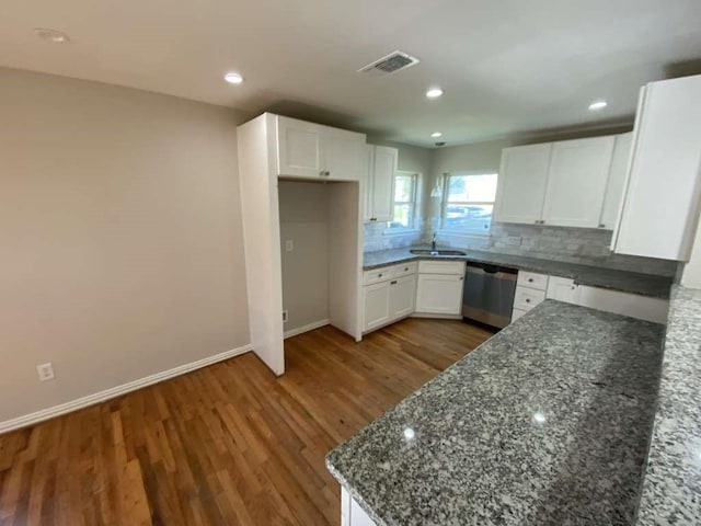 7209 La Salette St, Houston, TX 77021 - kitchen with dishwasher, a sink, dark stone countertops, wood finished floors, and white cabinets