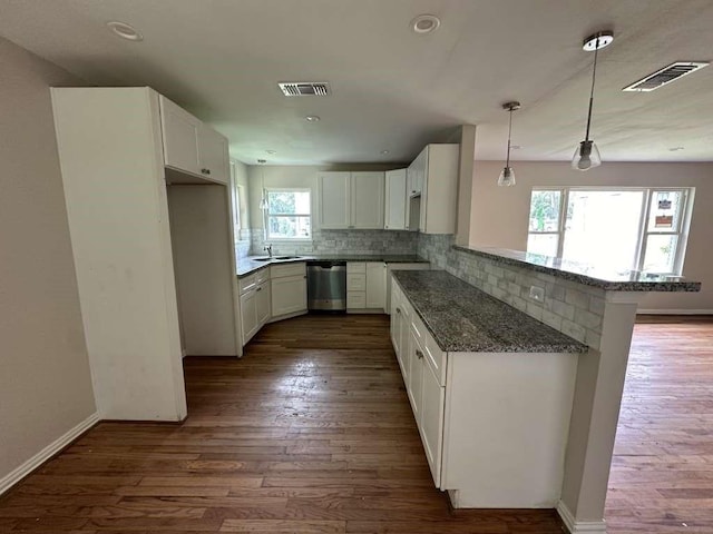7209 La Salette St, Houston, TX 77021 - kitchen with stainless steel dishwasher, decorative backsplash, dark stone counters, a sink, and dark wood-style flooring