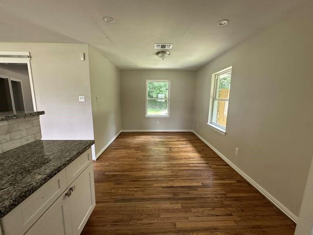 7209 La Salette St, Houston, TX 77021 - unfurnished dining area with dark wood-style floors and baseboards