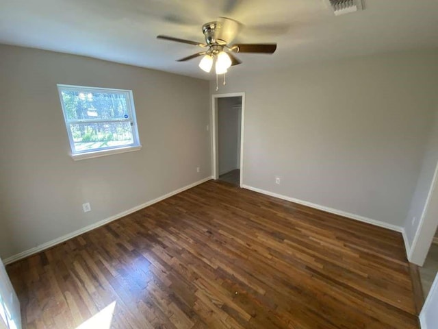 7209 La Salette St, Houston, TX 77021 - spare room featuring dark wood-style floors, a ceiling fan, and baseboards