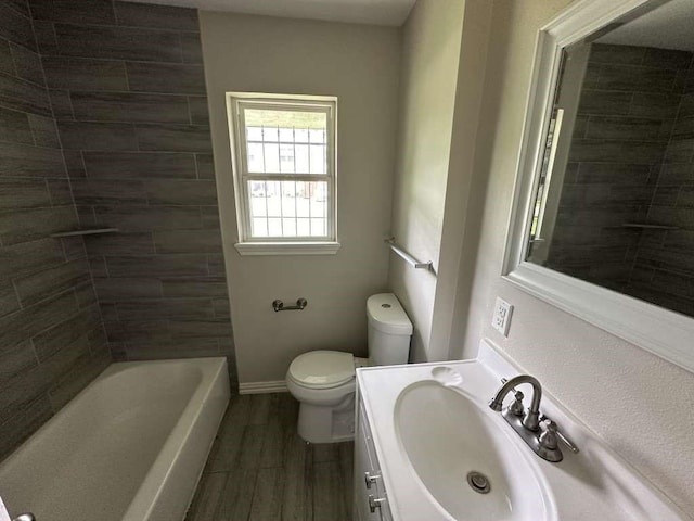 7209 La Salette St, Houston, TX 77021 - bathroom featuring toilet, wood finished floors, vanity, and baseboards