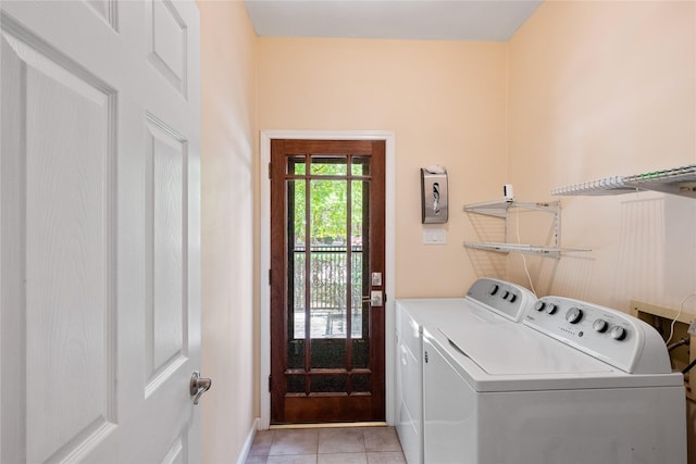 3114 Breezy Pines Ct, Kingwood, TX 77339 - washroom featuring washing machine and clothes dryer, light tile patterned floors, and baseboards