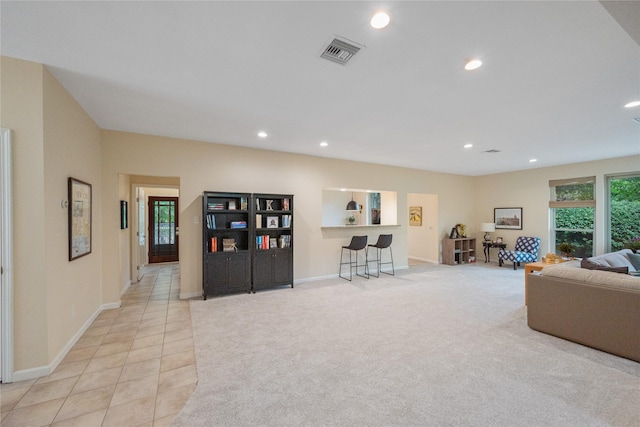 3114 Breezy Pines Ct, Kingwood, TX 77339 - living room featuring recessed lighting, light tile patterned floors, baseboards, and light colored carpet