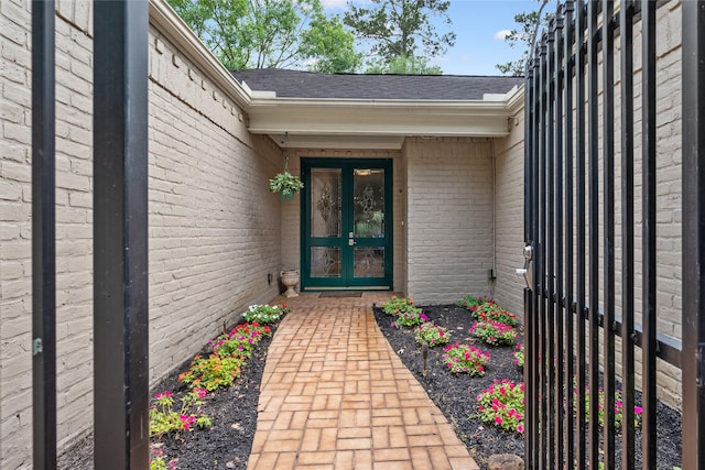 3114 Breezy Pines Ct, Kingwood, TX 77339 - view of exterior entry with brick siding and a shingled roof