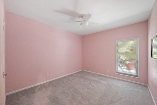 3114 Breezy Pines Ct, Kingwood, TX 77339 - spare room featuring carpet flooring, a ceiling fan, and baseboards