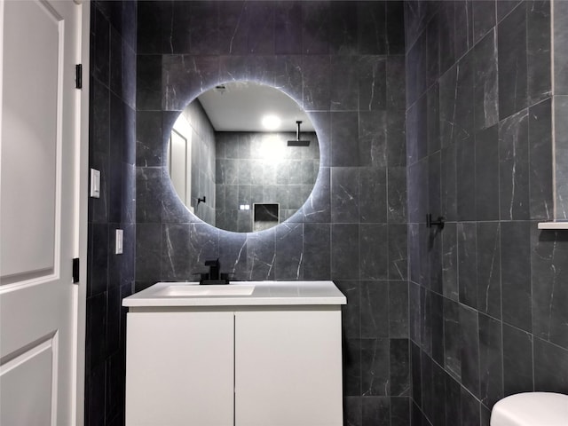 2225 W Clare St, Deer Park, TX 77536 - bathroom with vanity, tile walls, a tile shower, and toilet