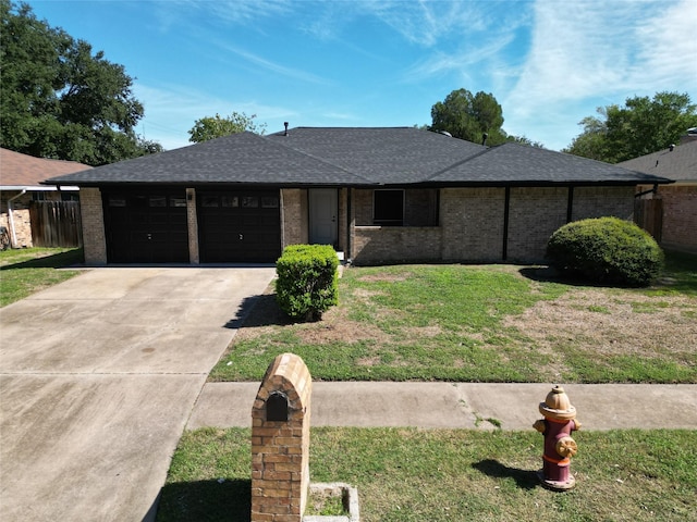 2225 W Clare St, Deer Park, TX 77536 - view of front of home with driveway, a garage, a front yard, and a shingled roof