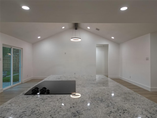 2225 W Clare St, Deer Park, TX 77536 - kitchen featuring black electric cooktop, light wood-style floors, vaulted ceiling, light stone countertops, and baseboards