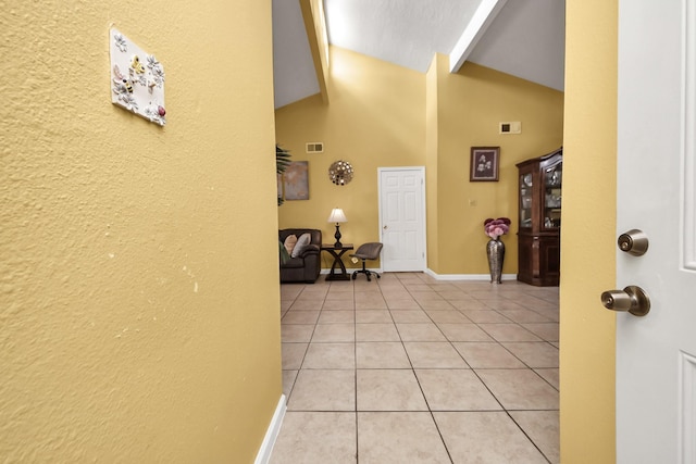 4155 Amir St, Houston, TX 77072 - foyer entrance featuring high vaulted ceiling, light tile patterned floors, baseboards, and a textured wall