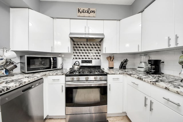 4155 Amir St, Houston, TX 77072 - kitchen featuring stainless steel appliances, under cabinet range hood, backsplash, white cabinetry, and light stone counters