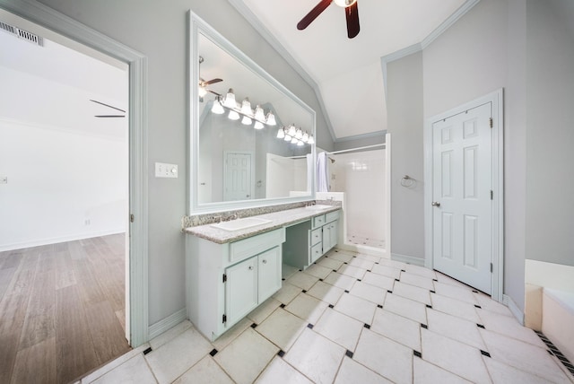 4910 Glen Hollow St, Sugar Land, TX 77479 - bathroom featuring ceiling fan, double vanity, a shower stall, vaulted ceiling, and baseboards