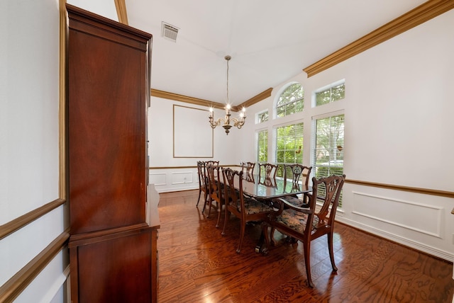 4910 Glen Hollow St, Sugar Land, TX 77479 - dining space with a decorative wall, a chandelier, dark wood-type flooring, ornamental molding, and a wainscoted wall