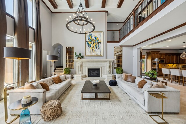2919 Auburn Path, Sugar Land, TX 77479 - living area featuring a high ceiling, a chandelier, a glass covered fireplace, recessed lighting, and arched walkways
