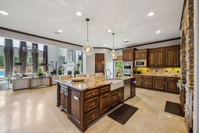 2919 Auburn Path, Sugar Land, TX 77479 - kitchen with a sink, stainless steel appliances, ornamental molding, decorative backsplash, and an island with sink