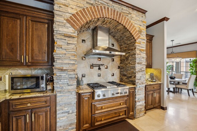 2919 Auburn Path, Sugar Land, TX 77479 - kitchen featuring appliances with stainless steel finishes, wall chimney range hood, tasteful backsplash, ornamental molding, and light stone countertops