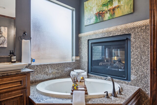 2919 Auburn Path, Sugar Land, TX 77479 - full bath featuring vanity, a whirlpool tub, and a glass covered fireplace