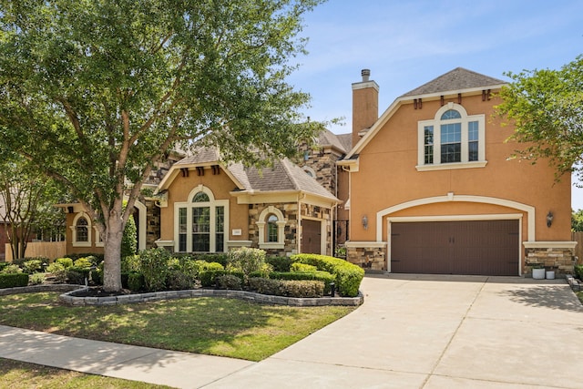 2919 Auburn Path, Sugar Land, TX 77479 - view of front of home featuring stone siding, a garage, stucco siding, a chimney, and driveway