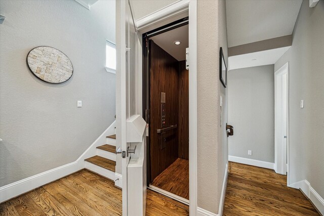 216 W Drew St, Houston, TX 77006 - corridor with baseboards, wood finished floors, and stairway