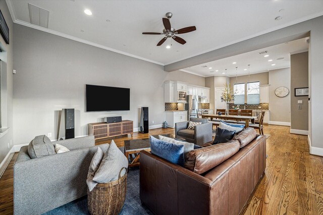 216 W Drew St, Houston, TX 77006 - living room with a ceiling fan, light wood-type flooring, recessed lighting, baseboards, and crown molding