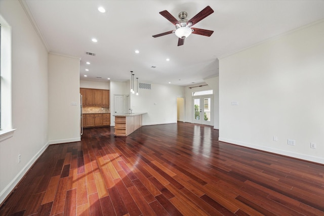 415 Tuam St, Houston, TX 77006 - unfurnished living room with ceiling fan, crown molding, recessed lighting, dark wood finished floors, and baseboards