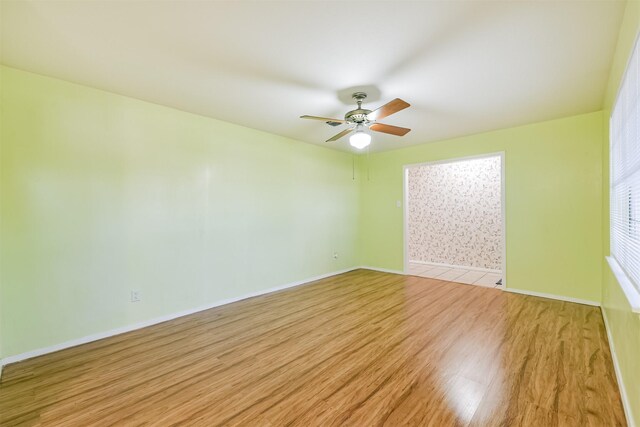 822 N Kaufman Dr, Deer Park, TX 77536 - empty room featuring a ceiling fan, light wood-type flooring, and baseboards