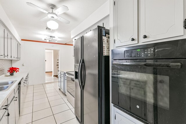822 N Kaufman Dr, Deer Park, TX 77536 - kitchen with black appliances, light tile patterned flooring, white cabinets, and backsplash