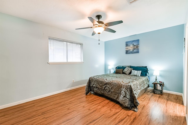 822 N Kaufman Dr, Deer Park, TX 77536 - bedroom featuring wood finished floors, baseboards, and a ceiling fan