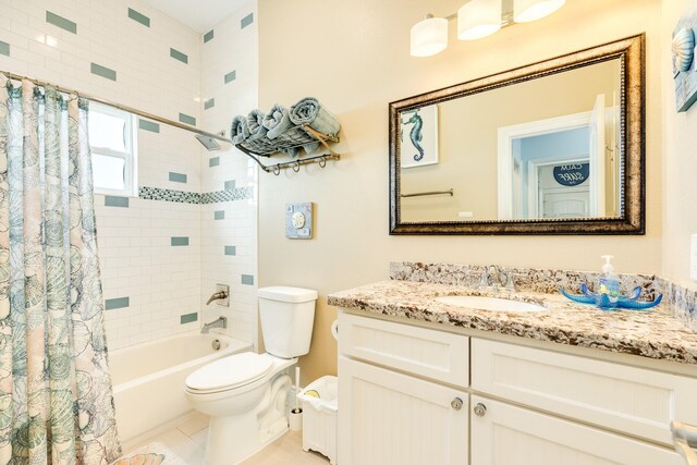 12881 Coronado Dr, Freeport, TX 77541 - full bathroom with toilet, shower / bath combo with shower curtain, vanity, and tile patterned flooring