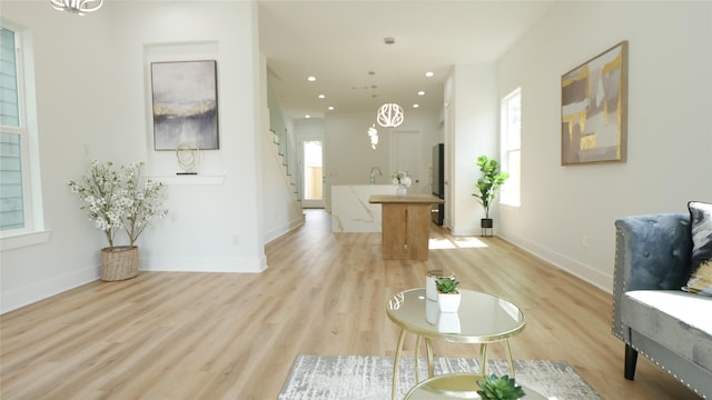 7805 Avenue Ave E, Houston, TX 77012 - living room featuring stairway, light wood finished floors, baseboards, and recessed lighting