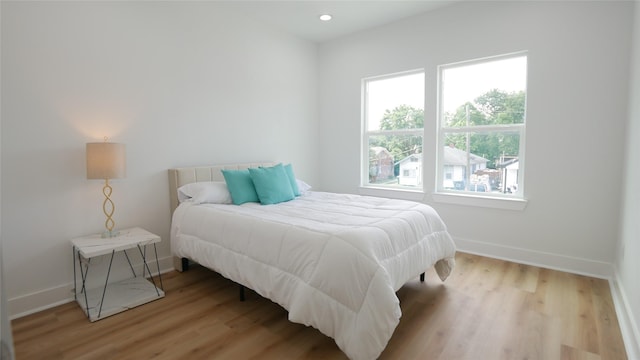 7805 Avenue Ave E, Houston, TX 77012 - bedroom featuring baseboards, wood finished floors, and recessed lighting