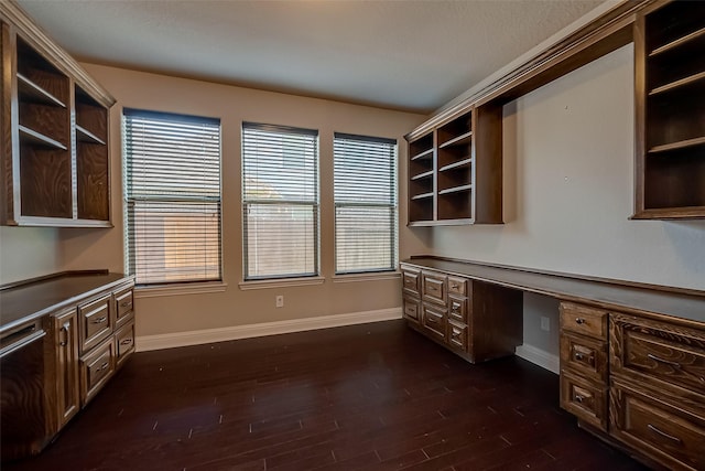 3307 Big Sky Pass, Missouri City, TX 77459 - unfurnished office featuring built in desk, baseboards, and dark wood-style flooring