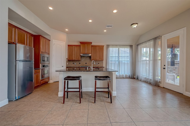 3307 Big Sky Pass, Missouri City, TX 77459 - kitchen with appliances with stainless steel finishes, under cabinet range hood, tasteful backsplash, a sink, and recessed lighting