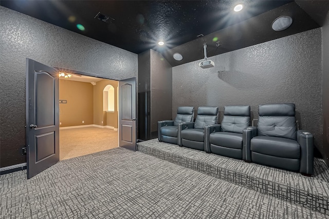 3307 Big Sky Pass, Missouri City, TX 77459 - cinema featuring carpet flooring, a textured wall, arched walkways, and baseboards