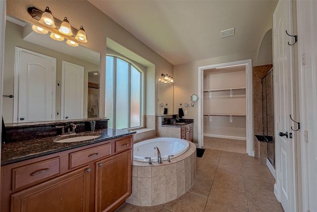 3307 Big Sky Pass, Missouri City, TX 77459 - bathroom with a shower stall, a bath, tile patterned floors, two vanities, and a walk in closet