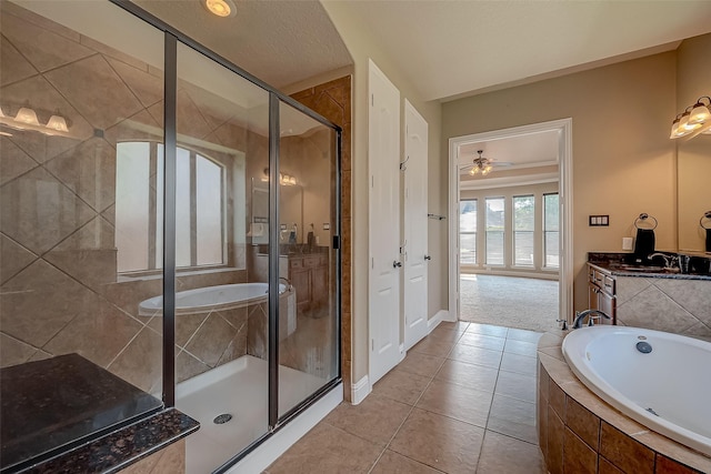 3307 Big Sky Pass, Missouri City, TX 77459 - full bathroom featuring a bath, a shower stall, a ceiling fan, tile patterned floors, and vanity