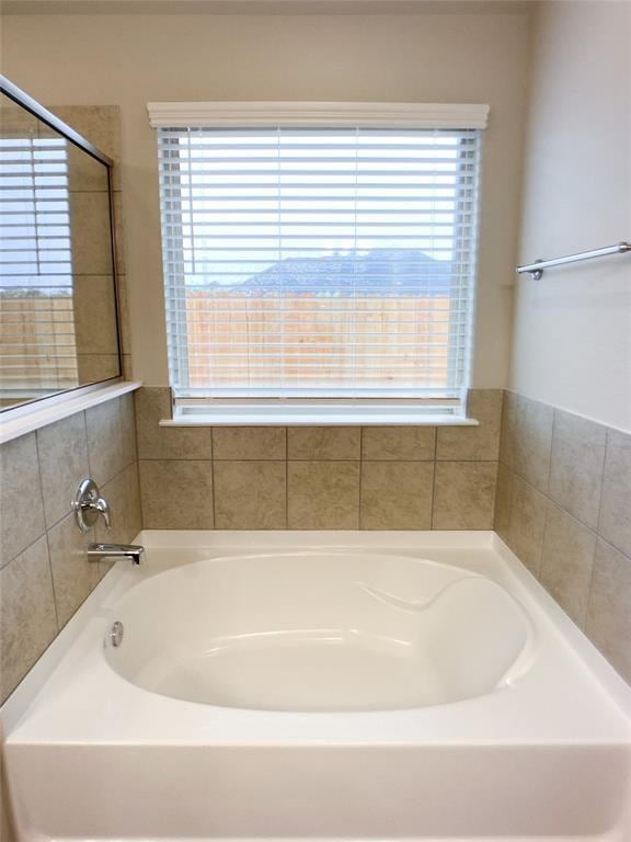 27315 Blue Pool Dr, Katy, TX 77493 - bathroom with healthy amount of natural light and a garden tub