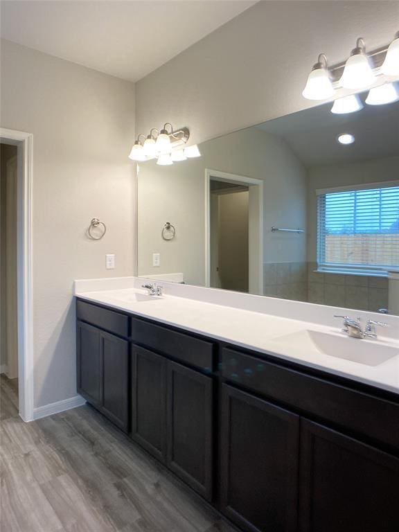 27315 Blue Pool Dr, Katy, TX 77493 - full bathroom featuring wood finished floors, double vanity, a chandelier, and baseboards