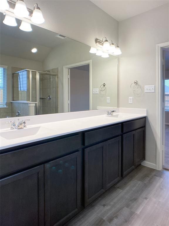 27315 Blue Pool Dr, Katy, TX 77493 - bathroom featuring a chandelier, wood finished floors, a shower stall, double vanity, and vaulted ceiling