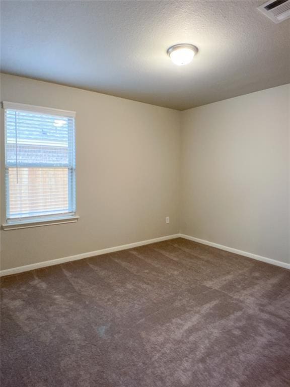27315 Blue Pool Dr, Katy, TX 77493 - spare room featuring dark carpet, baseboards, and a textured ceiling