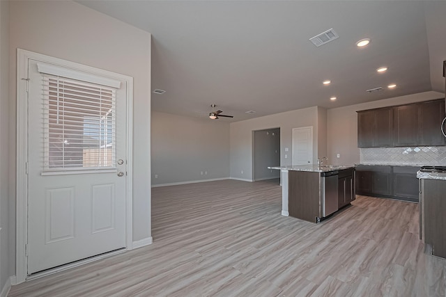 27315 Blue Pool Dr, Katy, TX 77493 - kitchen featuring stainless steel dishwasher, baseboards, a ceiling fan, tasteful backsplash, and light wood-style floors