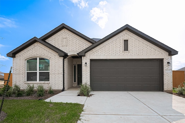27315 Blue Pool Dr, Katy, TX 77493 - french provincial home with brick siding, an attached garage, and concrete driveway