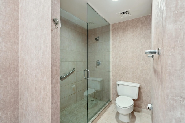 14 Greenway Plz Unit 19R, Houston, TX 77046 - bathroom featuring a shower stall, tile patterned flooring, and toilet