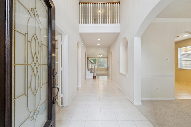 5111 Maple Hill Trl, Houston, TX 77345 - foyer entrance featuring arched walkways, healthy amount of natural light, tile patterned flooring, baseboards, and ornamental molding
