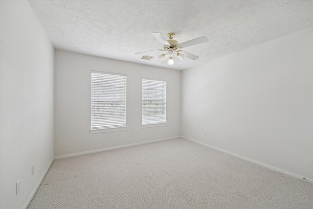 5111 Maple Hill Trl, Houston, TX 77345 - empty room with light carpet, a ceiling fan, baseboards, and a textured ceiling