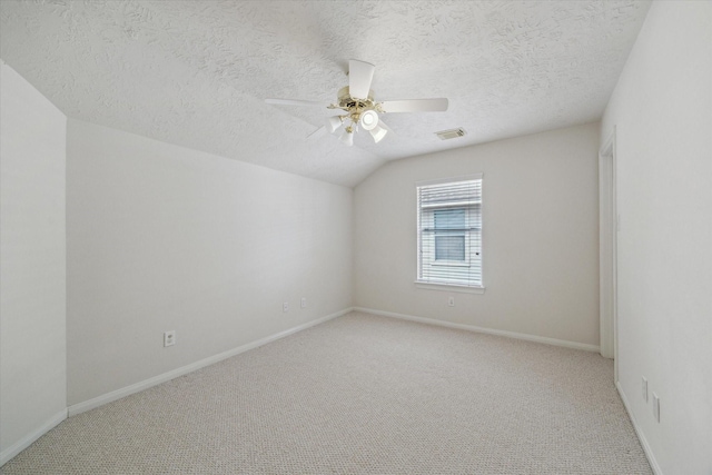 5111 Maple Hill Trl, Houston, TX 77345 - spare room featuring ceiling fan, light carpet, a textured ceiling, baseboards, and vaulted ceiling
