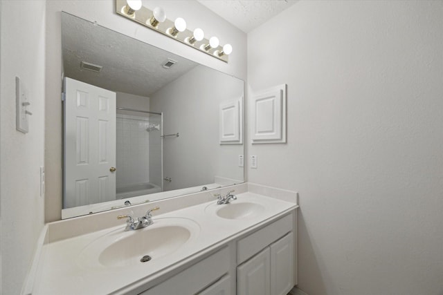5111 Maple Hill Trl, Houston, TX 77345 - full bathroom with a textured ceiling, double vanity, and shower / bath combination