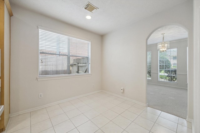 5111 Maple Hill Trl, Houston, TX 77345 - unfurnished room with arched walkways, a chandelier, baseboards, light tile patterned flooring, and recessed lighting