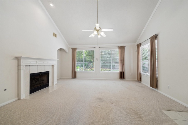 5111 Maple Hill Trl, Houston, TX 77345 - unfurnished living room with vaulted ceiling, ceiling fan, crown molding, a tile fireplace, and carpet